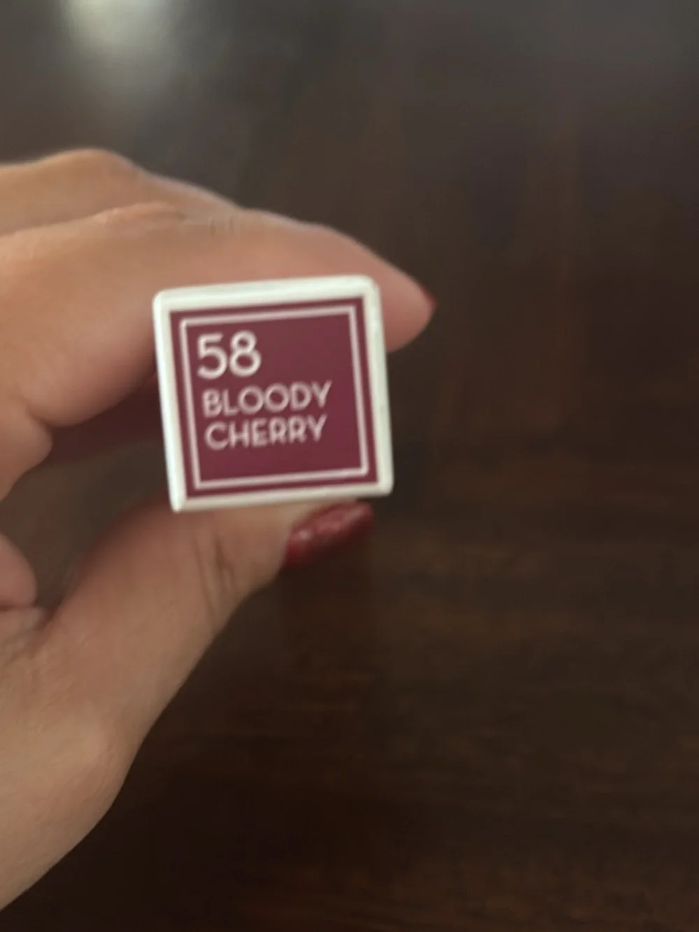 BOODY Lip Gloss - Shiny White Packaging with Red Nails Visible